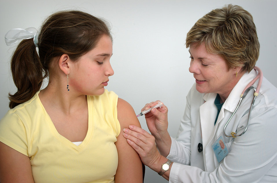 16727 a nurse giving a young girl a vaccine shot pv