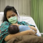 Hispanic mom wearing mask with newborn | OBHG